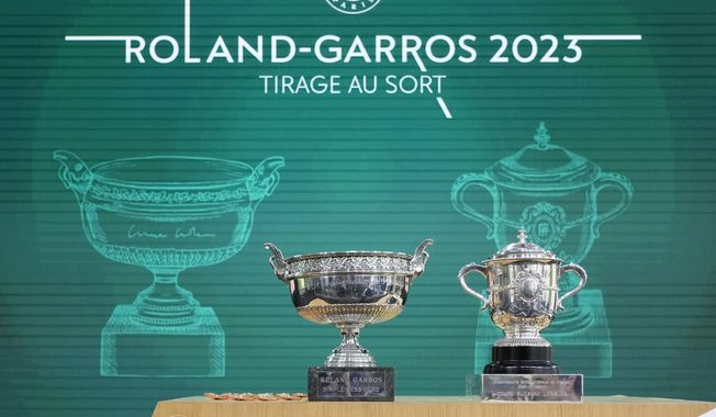 The men&#x27;s trophy, left, and the women&#x27;s trophy are presented during the French Open tennis tournament draw at the Roland Garros Stadium, Thursday, May 25, 2023 in Paris. Play begins at the French Open on Sunday, May 28, 2023 and runs until Sunday June 11,2023. (AP Photo/Thibault Camus)