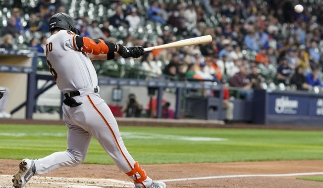 San Francisco Giants&#x27; Michael Conforto hits a single during the fourth inning of a baseball game against the Milwaukee Brewers Thursday, May 25, 2023, in Milwaukee. (AP Photo/Morry Gash)