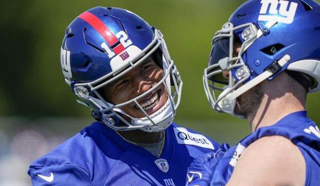 New York Giants tight ends Darren Waller, left, and Daniel Bellinger, right, laugh on the sidelines of practice at the NFL football team&#x27;s practice facility, Thursday, May 25, 2023, in East Rutherford, N.J. (AP Photo/John Minchillo)