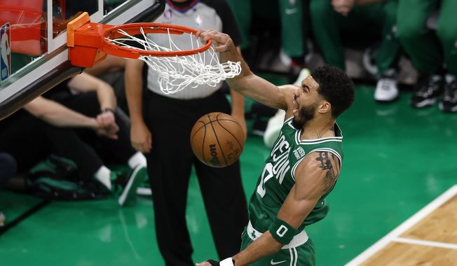 Boston Celtics forward Jayson Tatum dunks during the first half in Game 5 of an NBA basketball Eastern Conference Final series against the Miami Heat Thursday, May 25, 2023, in Boston. (AP Photo/Michael Dwyer)