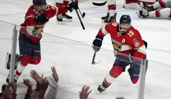 Florida Panthers left wing Matthew Tkachuk (19) reacts after scoring the game-winning goal against the Carolina Hurricanes in the waning seconds of the third period of Game 4 of the NHL hockey Stanley Cup Eastern Conference finals Wednesday, May 24, 2023, in Sunrise, Fla. At left is Panthers center Sam Reinhart (13). (AP Photo/Lynne Sladky)