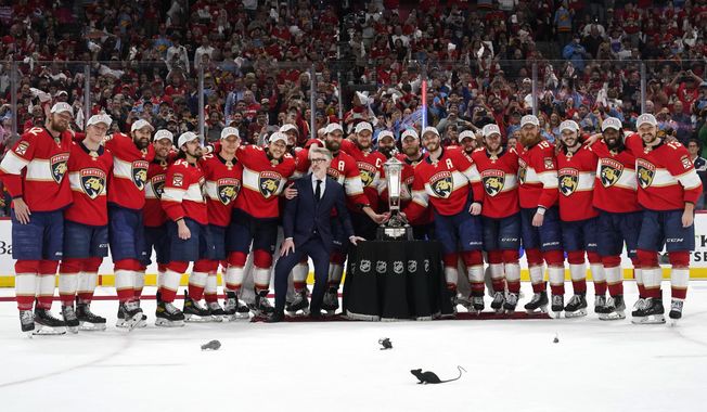 The Florida Panthers pose with the Prince of Wales trophy after winning Game 4 of the NHL hockey Stanley Cup Eastern Conference finals against the Carolina Hurricanes, Wednesday, May 24, 2023, in Sunrise, Fla. (AP Photo/Wilfredo Lee)