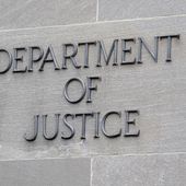 A sign marks the facade of the Robert F. Kennedy Department of Justice Building, May 5, 2022, in Washington. The Justice Department issued new guidance Thursday, May 25, 2023, emphasizing that investigations must be free from bias involving race and gender or against people with disabilities. Anti-profiling rules were also expanded to include thousands more people who are part of the justice system. (AP Photo/Patrick Semansky) **FILE**