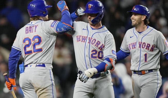New York Mets&#x27; Pete Alonso, center, celebrates with Brett Baty, left, and Jeff McNeil after hitting a two-run home run against the Chicago Cubs during the seventh inning of a baseball game in Chicago, Thursday, May 25, 2023. (AP Photo/Nam Y. Huh)
