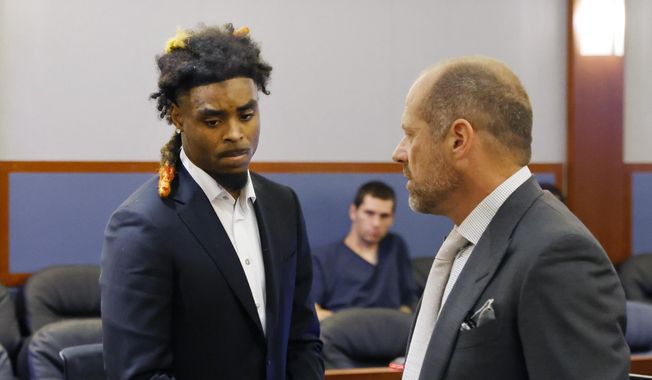 Former NFL cornerback Damon Arnette leaves the courtroom with his attorney Ross Goodman following his arraignment at the Regional Justice Center, Wednesday, May 24, 2023, in Las Vegas. Arnette pleaded not guilty to felony charges alleging that he brandished a handgun during an argument with Las Vegas Strip casino valets in January 2022, and his lawyer is challenging his indictment. (Bizuayehu Tesfaye/Las Vegas Review-Journal via AP)