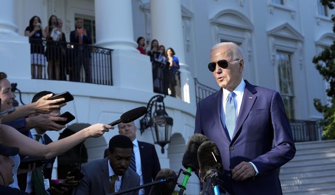 President Joe Biden talks with reporters on the South Lawn of the White House in Washington, Friday, May 26, 2023, as he heads to Camp David for the weekend. (AP Photo/Susan Walsh)