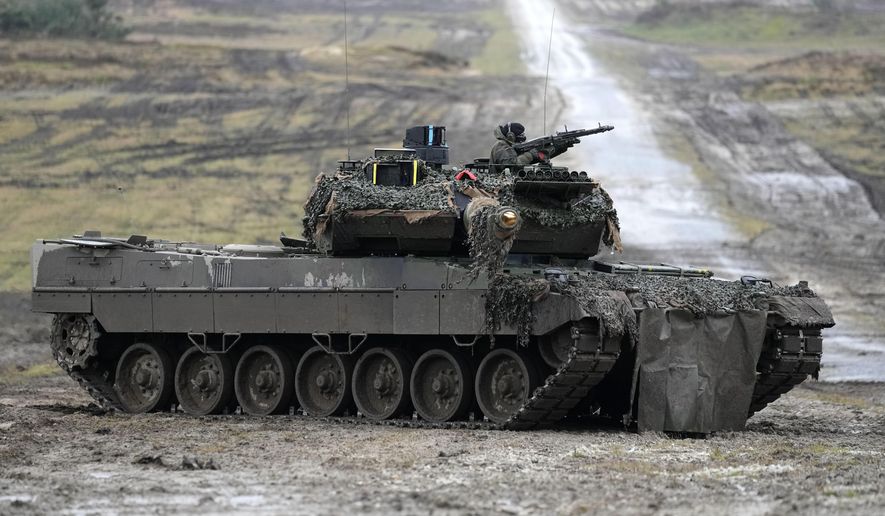 A Leopard 2 tank is seen in action during a visit of German Defense Minister Boris Pistorius at the Bundeswehr tank battalion 203 at the Field Marshal Rommel Barracks in Augustdorf, Germany, on Feb. 1, 2023. The German military has ordered 18 new Leopard 2 tanks to replace vehicles that were sent to Ukraine earlier this year, a leading defense company said Friday, May 26, 2023. (AP Photo/Martin Meissner, File)