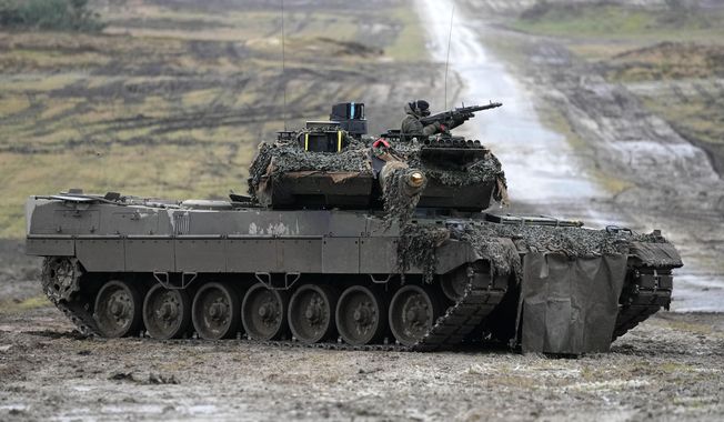 A Leopard 2 tank is seen in action during a visit of German Defense Minister Boris Pistorius at the Bundeswehr tank battalion 203 at the Field Marshal Rommel Barracks in Augustdorf, Germany, on Feb. 1, 2023. The German military has ordered 18 new Leopard 2 tanks to replace vehicles that were sent to Ukraine earlier this year, a leading defense company said Friday, May 26, 2023. (AP Photo/Martin Meissner, File)
