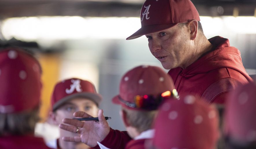 Alabama coach Brad Bohannon talks with the team in the dugout after Alabama rallied in the bottom of the ninth for a 5-4 win over Xavier in an NCAA college baseball game Feb. 18, 2022, in Tuscaloosa, Ala. An Indiana man whose son is a member of the University of Cincinnati baseball team is the bettor at the center of separate investigations that led to firings of Bohannon and two members of the Cincinnati baseball staff this month, two people familiar with the inquiries told The Associated Press on Friday, May 26. (AP Photo/Vasha Hunt, File)