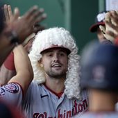 Washington Nationals&#x27; Lane Thomas celebrates in the dugout after hitting a solo home run during the first inning of a baseball game against the Kansas City Royals Friday, May 26, 2023, in Kansas City, Mo. (AP Photo/Charlie Riedel)