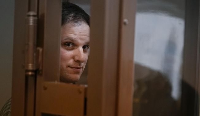 Wall Street Journal reporter Evan Gershkovich stands in a glass cage in a courtroom at the Moscow City Court, in Moscow, Russia, on April 18, 2023. Gershkovich, a 31-year-old U.S. citizen, was arrested in March while on a reporting trip in Russia. He, his employer and the U.S. government have denied the charges. A Moscow court on Tuesday extended his detention until Aug. 30, and the journalist has appealed the ruling. (AP Photo/Alexander Zemlianichenko, File)