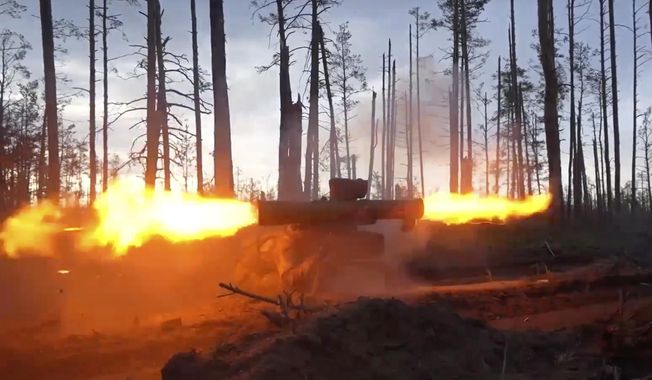 In this handout photo taken from video released by Russian Defense Ministry Press Service on Thursday, May 25, 2023, a Russian army soldier fires a Fagot anti-tank missile system toward Ukrainian position at an undisclosed location. (Russian Defense Ministry Press Service photo via AP)