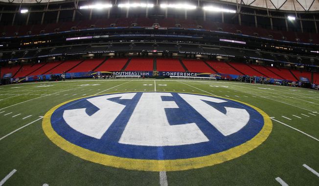 FILE - The SEC logo is displayed on the field ahead of the Southeastern Conference championship football game between Alabama and Missouri on Dec. 5, 2014, in Atlanta. Southeastern Conference leaders will continue debating what to do with their football schedule when they meet in the Florida Panhandle starting Tuesday, May 30, 2023. (AP Photo/John Bazemore, File)