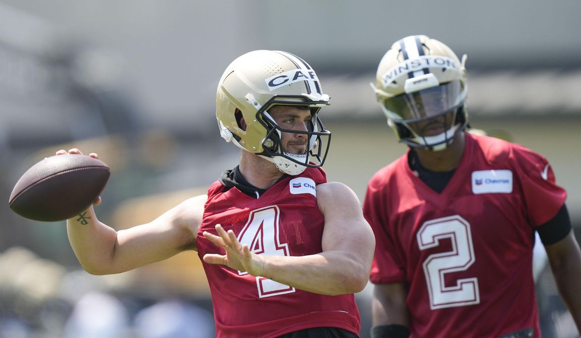 New Orleans Saints quarterback Derek Carr passes as quarterback Jameis Winston (2) watches during an NFL football practice in Metairie, La., Tuesday, May 23, 2023. (AP Photo/Gerald Herbert)
