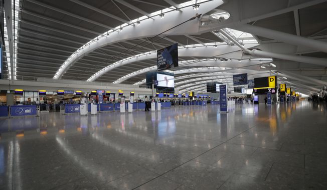 Terminal 5 at Heathrow Airport in London, which handles British Airways flights, stands virtually empty of passengers as staff standby to help during a British Airways pilots&#x27; strike, Monday, Sept. 9, 2019. The British government is working to fix a technical problem that caused electronic border gates at airports around the country to stop working late Friday, leading to hourslong waits for travelers entering the U.K. at the start of a busy holiday weekend. (AP Photo/Matt Dunham, File)