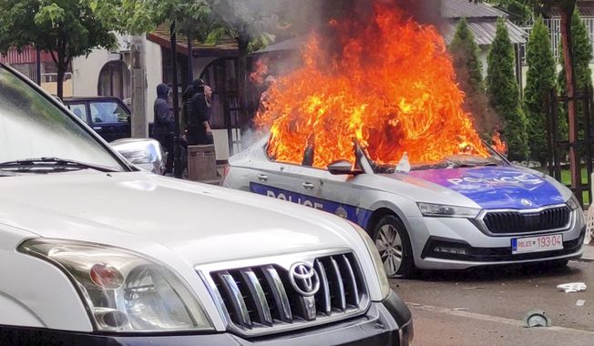 In this image made from video, Kosovar police car burns in Zvecan, northern Kosovo Friday, May 26, 2023. Serbia put its troops on the border with Kosovo on the highest state of alert Friday following clashes between ethnic Serbs and Kosovo police that left more than a dozen injured on both sides. (AP Photo)