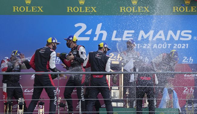 The Toyota Gazoo Racing&#x27;s winner drivers Mike Conway of Britain, Kamui Kobayashi of Japan and Jose Maria Lopez of Argentina, and the second placed drivers Sebastien Buemi of Switzerland, Kazuki Nakajima of Japan and Brendon Hartley of New Zeland celebrate on the podium of the 24-hour Le Mans endurance race in Le Mans, France, on Aug. 22, 2021. The world&#x27;s most famous endurance race will be open to hydrogen-powered cars starting in 2026, Pierre Fillon, the president of the Automobile Club de l&#x27;Ouest, said Saturday, May 27, 2023. (AP Photo/Francois Mori, File)
