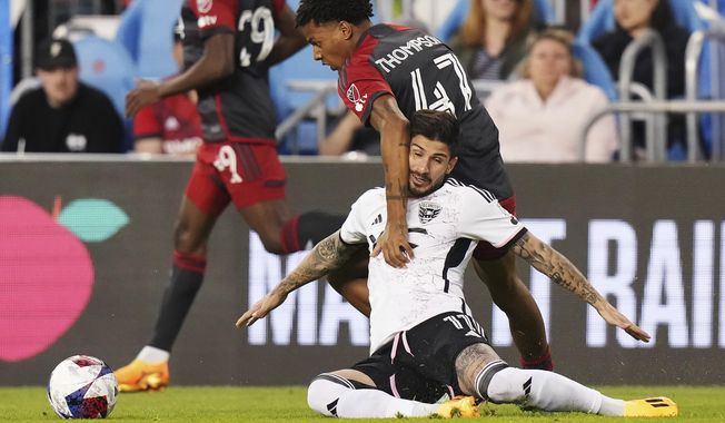 Toronto FC midfielder Kosi Thompson (47) battles with D.C. United forward Taxiarchis Fountas (11) during second-half MLS soccer match action in Toronto, Ontario, Saturday, May 27, 2023. (Chris Young/The Canadian Press via AP)
