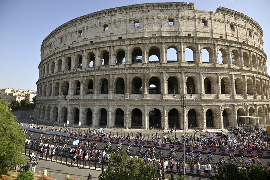 The pack of cyclists pedals past the Colosseum, during the last stage of the Giro d'Italia cycling race, in Rome, Sunday, May 28, 2023. (Fabio Ferrari/LaPresse via AP) ** FILE **