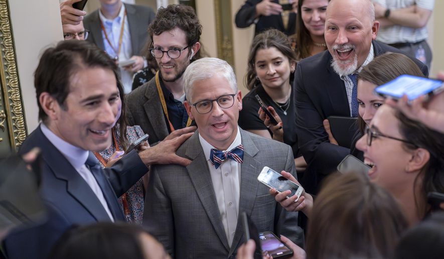 Top Republican debt crisis mediators Rep. Garret Graves, R-La., left, and Rep. Patrick McHenry, R-N.C., center, chairman of the House Financial Services Committee, with Rep. Chip Roy, R-Texas, upper right, have a laugh as they stop for questions by reporters on progress in the talks with the Biden administration, at the Capitol in Washington, Tuesday, May 23, 2023. Rep. Chip Roy, R-Texas, a member of the conservative House Freedom Caucus, has blasted the tentative debt ceiling deal struck by Speaker Kevin McCarthy, R-Calif., and President Joe Biden and says he will try to stop it in the House. (AP Photo/J. Scott Applewhite, File)