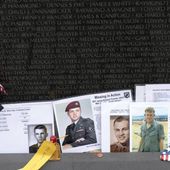 Photographs of fallen soldiers line the wall at the Vietnam Veterans Memorial ahead of Memorial Day, in Washington, Sunday, May 28, 2023. (AP Photo/Jose Luis Magana)