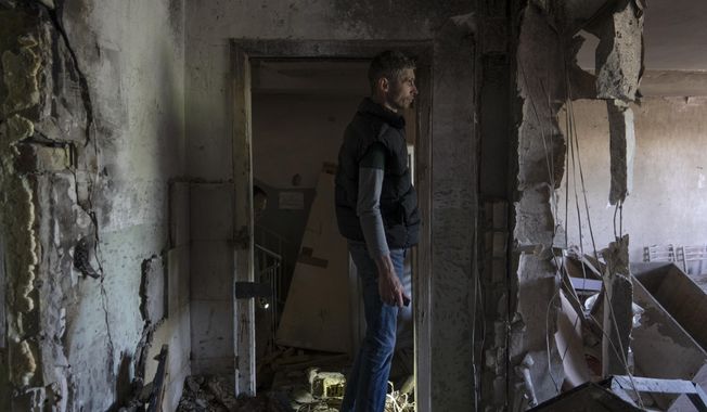 A man inspects his office damaged by a drone during a night attack, in Kyiv, Ukraine, Sunday, May 28, 2023. Ukraine&#x27;s capital was subjected to the largest drone attack since the start of Russia&#x27;s war, local officials said, as Kyiv prepared to mark the anniversary of its founding on Sunday. (AP Photo/Vasilisa Stepanenko)