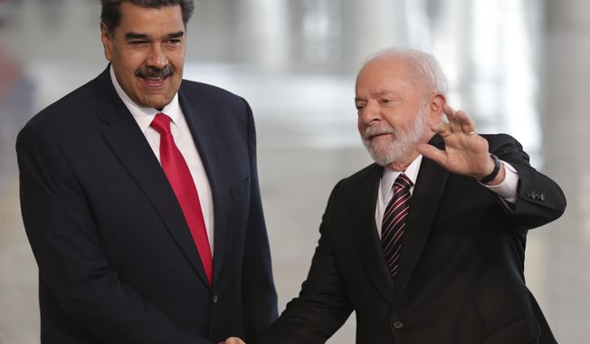 Brazilian President Luiz Inacio Lula da Silva, right, shakes hands with Venezuela&#x27;s President Nicolas Maduro prior to their bilateral meeting at Planalto palace in Brasilia, Brazil, Monday, May 29, 2023. Maduro is in Brazil for the Union of South American Nations (UNASUR) summit that starts on Tuesday. (AP Photo/Gustavo Moreno)