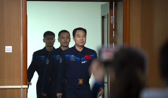 Chinese astronauts for the upcoming Shenzhou-16 mission, front to back, Jing Haipeng, Zhu Yangzhu, and Gui Haichao arrive for a meeting of the press at the Jiuquan Satellite Launch Center in northwest China on Monday, May 29, 2023. China&#x27;s space program plans to land astronauts on the moon before 2030, a top official with the country&#x27;s space program said Monday. (AP Photo/Mark Schiefelbein)