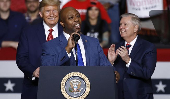 FILE - Sen. Tim Scott, R-S.C., speaks in front of President Donald Trump and Sen. Lindsey Graham, R-S.C., during a campaign rally, Friday, Feb. 28, 2020, in North Charleston, S.C. When Scott launched his campaign for the White House last week, the notoriously prickly former President Donald Trump welcomed his new competitor with open arms. “Good luck to Senator Tim Scott in entering the Republican Presidential Primary Race,” Trump said. (AP Photo/Patrick Semansky, File)