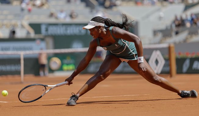 Sloane Stephens of the U.S. slides t play a shot against Karolina Pliskova of the Czech Republic during their first round match of the French Open tennis tournament at the Roland Garros stadium in Paris, Monday, May 29, 2023. (AP Photo/Jean-Francois Badias)