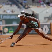 Sloane Stephens of the U.S. slides t play a shot against Karolina Pliskova of the Czech Republic during their first round match of the French Open tennis tournament at the Roland Garros stadium in Paris, Monday, May 29, 2023. (AP Photo/Jean-Francois Badias)