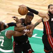 Boston Celtics guard Jaylen Brown, left, and Miami Heat forward Jimmy Butler, center, grapple for the ball along with forward Caleb Martin during the first half in Game 7 of the NBA basketball Eastern Conference finals Monday, May 29, 2023, in Boston. (AP Photo/Michael Dwyer)