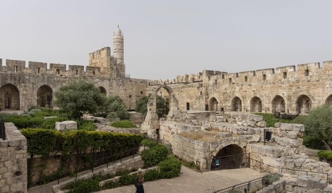A woman walks at the inner courtyard of the Tower of David Museum, in Jerusalem&#x27;s Old City, after a three-year renovation project, Monday, May 22, 2023. The tower, an ancient fortress on the western edge of the Old City, contains remnants of successive fortifications built one atop the other dating back over two millennia. (AP Photo/Ohad Zwigenberg)