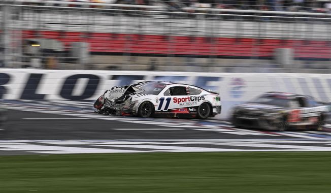 Denny Hamlin (11) crashes on the front stretch during a NASCAR Cup Series auto race at Charlotte Motor Speedway, Monday, May 29, 2023, in Concord, N.C. (AP Photo/Matt Kelley)