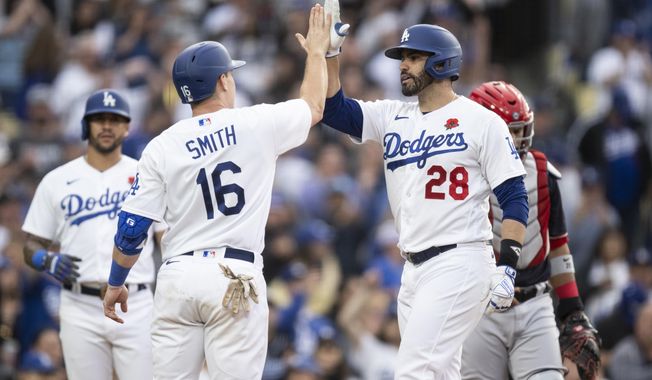 Los Angeles Dodgers designated hitter J.D. Martinez (28) celebrates after his three-run home run with Will Smith (16) during the fifth inning of a baseball game against the Washington Nationals in Los Angeles, Monday, May 29, 2023. (AP Photo/Kyusung Gong)