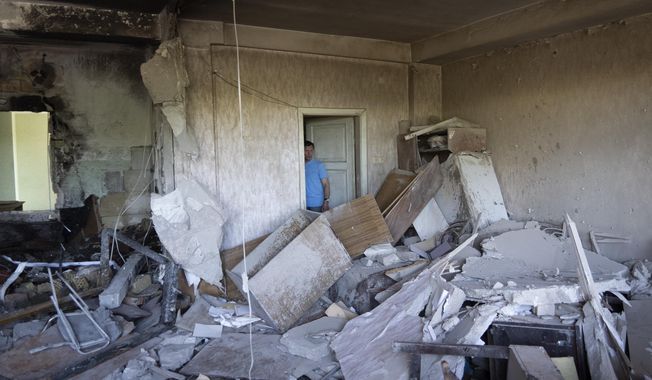 Vladimir Golubenko looks at his office damaged by a drone during a night attack, in Kyiv, Ukraine, Sunday, May 28, 2023. Ukraine&#x27;s capital was subjected to the largest drone attack since the start of Russia&#x27;s war, local officials said, as Kyiv prepared to mark the anniversary of its founding on Sunday. (AP Photo/Vasilisa Stepanenko)