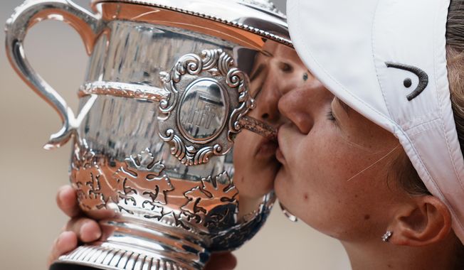 Czech Republic&#x27;s Barbora Krejcikova kisses the French Open trophy after defeating Russia&#x27;s Anastasia Pavlyuchenkova during their final match of the French Open tennis tournament at Roland Garros stadium in Paris, Saturday, June 12, 2021. Krejcikova is trying not to think too much about her past two trips to the French Open as she prepares to play her first-round match Tuesday, May 31, 2023 in Paris. Two years ago, she arrived relatively unknown and relatively unaccomplished and left with championships in both singles and doubles, something no woman had done at Roland Garros in more than 20 years. (AP Photo/Thibault Camus, File)