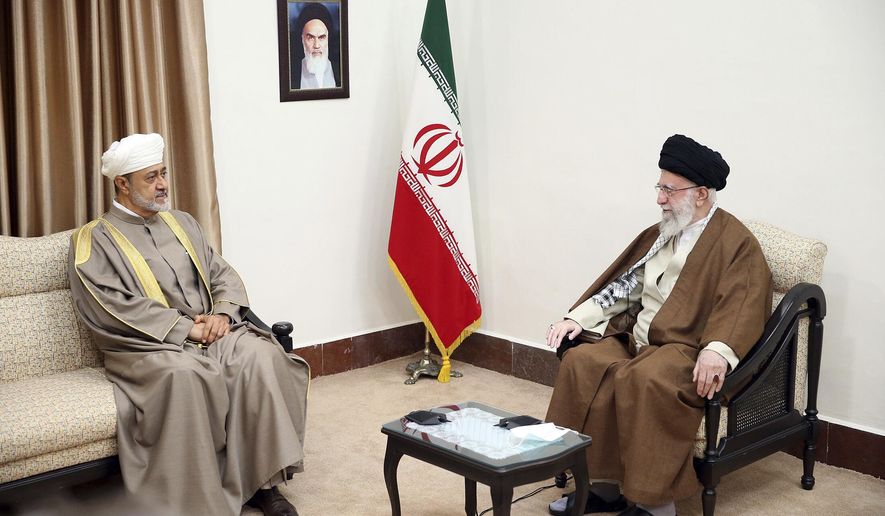 In this picture released by the office of the Iranian supreme leader, Supreme Leader Ayatollah Ali Khamenei, right, meets with Oman&#x27;s Sultan Haitham bin Tariq Al Said, in Tehran, Iran, Monday, May 29, 2023. A portrait of the late Iranian revolutionary founder Ayatollah Khomeini hangs on the wall. (Office of the Iranian Supreme Leader via AP)