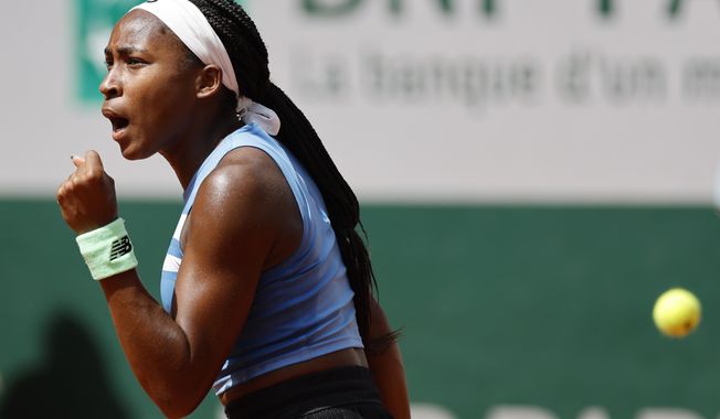 Coco Gauff of the U.S. celebrates winning her first round match of the French Open tennis tournament against Spain&#x27;s Rebeka Masarova in three sets, 3-6, 6-1, 6-2, at the Roland Garros stadium in Paris, Tuesday, May 30, 2023. (AP Photo/Jean-Francois Badias)