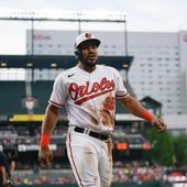 Baltimore Orioles&#x27; Anthony Santander walks to the dugout after scoring on a sacrifice fly ball by Austin Hays during the second inning of a baseball game against the Cleveland Guardians, Tuesday, May 30, 2023, in Baltimore. (AP Photo/Julio Cortez)