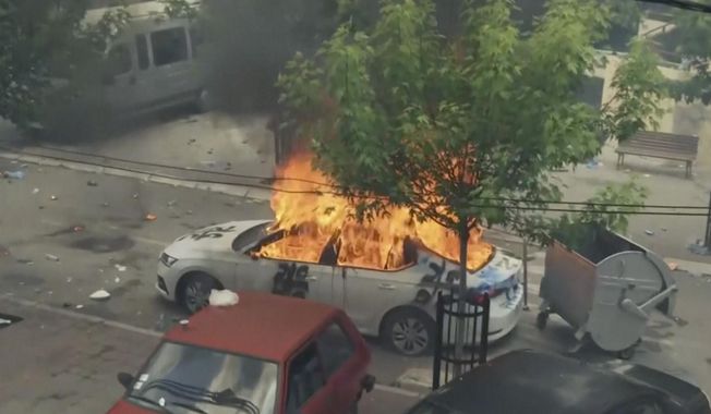 In this grab taken from video, a view of a car set on fire as KFOR soldiers clash with Kosovo Serbs in the town of Zvecan, northern Kosovo, Monday, May 29, 2023. Ethnic Serbs in northern Kosovo have clashed with troops from the NATO-led KFOR peacekeeping force outside a municipal building. They were trying to take over one of the local government offices where ethnic Albanian mayors entered last week with the help of the authorities. (AP Photo)