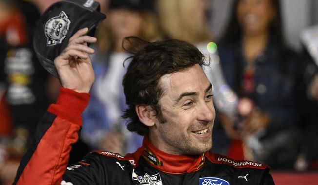 Ryan Blaney smiles in Victory Lane after winning a NASCAR Cup Series auto race at Charlotte Motor Speedway, Monday, May 29, 2023, in Concord, N.C. (AP Photo/Matt Kelley)