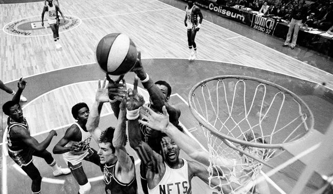 Denver Nuggets&#x27; Bobby Jones, second left, Nets&#x27; Julius Erving, fourth left, and New York Nets&#x27; Jim Eakins, right, battle for a rebound during the ABA championship playoff game at the Nassau Coliseum in Uniondale, N.Y., on May 14, 1976. The Denver Nuggets are the last of the four ABA teams that merged with the NBA to reach the Finals and is stirring up fond memories of the defunct league. (AP Photo/Richard Drew, File)