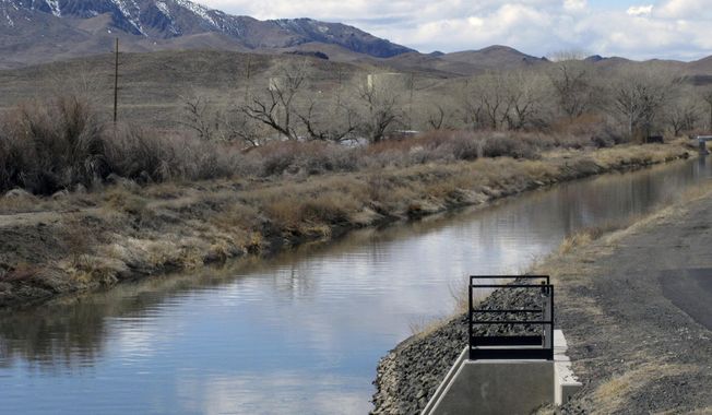 Water is shown in an irrigation canal in Fernley, Nev. near Reno on March 18, 2021. A U.S. appeals court has breathed new life into a rural Nevada&#x27;s town&#x27;s unusual bid to halt government repairs to an aging, federal irrigation canal that burst and flooded nearly 600 homes 15 years ago. The town of Fernley, area farmers and ranchers in the high desert 30 miles east of Reno say the renovation that finally began this year might help guard against another failure of the 118-year-old earthen canal. (AP Photo/Scott Sonner, File)