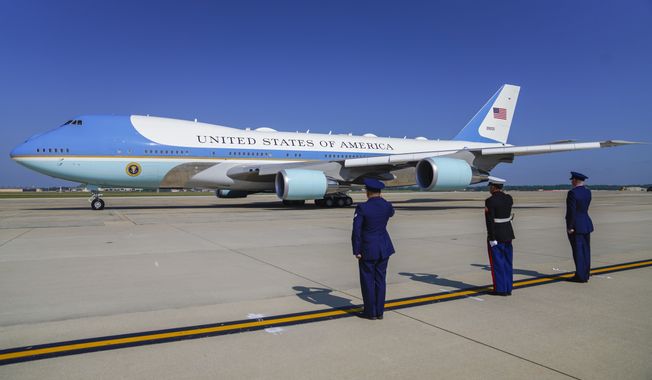 Officers salute as Air Force One takes off with President Joe Biden aboard at Andrews Air Force Base, Md., Wednesday, May 31, 2023, to travel to Colorado Springs, Colo. (AP Photo/Jess Rapfogel)