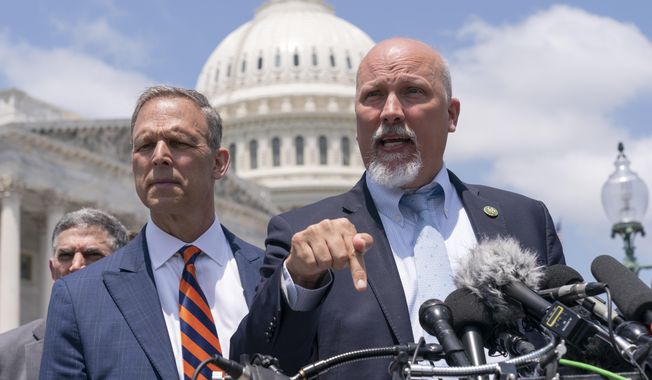 Rep. Scott Perry, R-Pa., left, and Rep. Chip Roy, R-Texas, speak with reporters as members of the conservative House Freedom Caucus talk about the debt limit deal, during a news conference, Tuesday, May 30, 2023, on Capitol Hill in Washington. (AP Photo/Jacquelyn Martin) ** FILE **