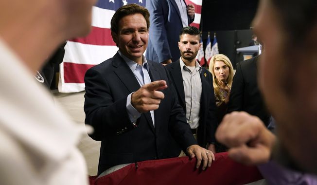 Republican presidential candidate Florida Gov. Ron DeSantis greets audience members during a campaign event, Tuesday, May 30, 2023, in Clive, Iowa. (AP Photo/Charlie Neibergall)