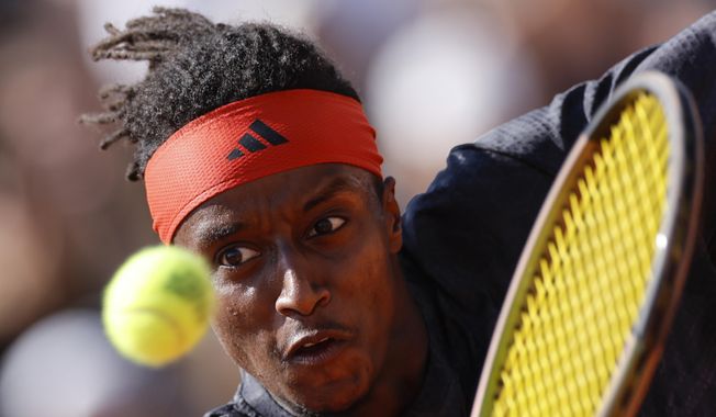 Sweden&#x27;s Mikael Ymer plays a shot against Italy&#x27;s Lorenzo Musetti during their first round match of the French Open tennis tournament at the Roland Garros stadium in Paris, Sunday, May 28, 2023. (AP Photo/Jean-Francois Badias)