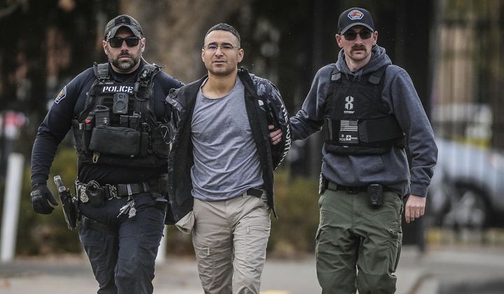 Solomon Peña, center, a Republican candidate for New Mexico House District 14, is taken into custody by Albuquerque, New Mexico, Police officers, Jan. 16, 2023, in southwest Albuquerque. Peña has been indicted on federal charges including interference with the electoral process in connection with a series of drive-by shootings at the homes of state and local lawmakers in Albuquerque, according to a grand jury indictment that was unsealed Wednesday, May 31. (Roberto E. Rosales/The Albuquerque Journal via AP, File)