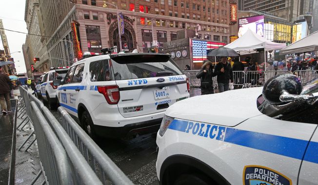 A line of police cars are parked along a street in Times Square, Thursday, Dec. 29, 2016, in New York. A New York City police officer is speaking out against the use of &quot;courtesy cards&quot; by friends and relatives of his colleagues on the force, accusing department leaders of maintaining a sprawling system of impunity that lets people with a connection to law enforcement avoid traffic tickets. (AP Photo/Kathy Willens, File)